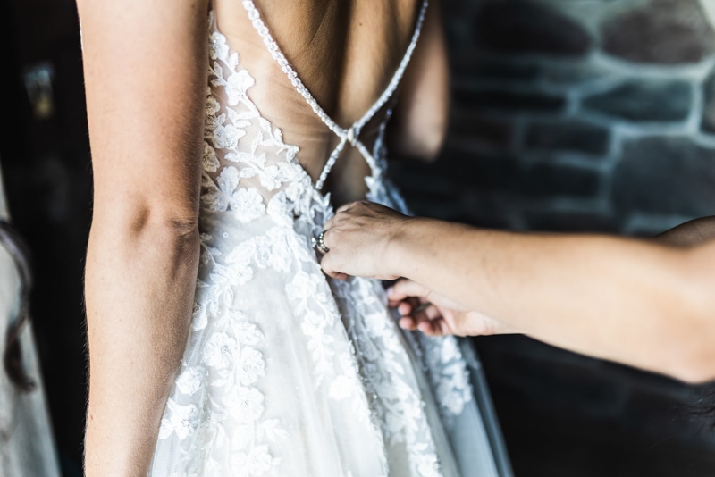Zipping back of wedding dress