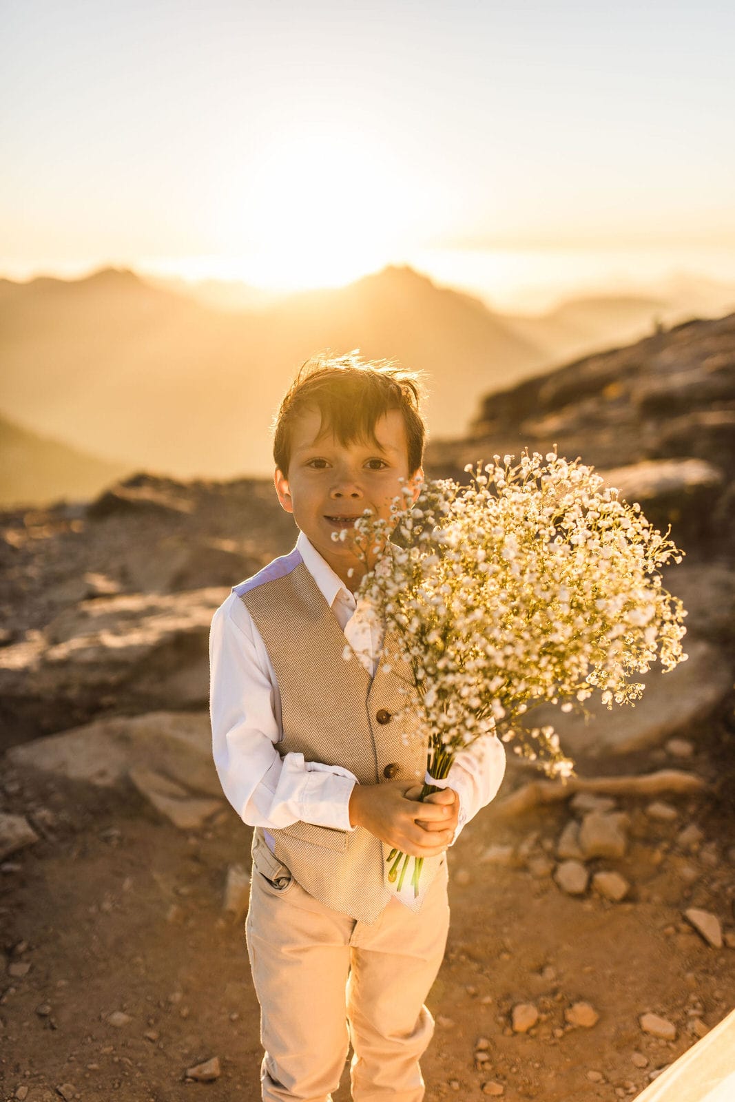 Boy holding a flower bouquet on mount rainier