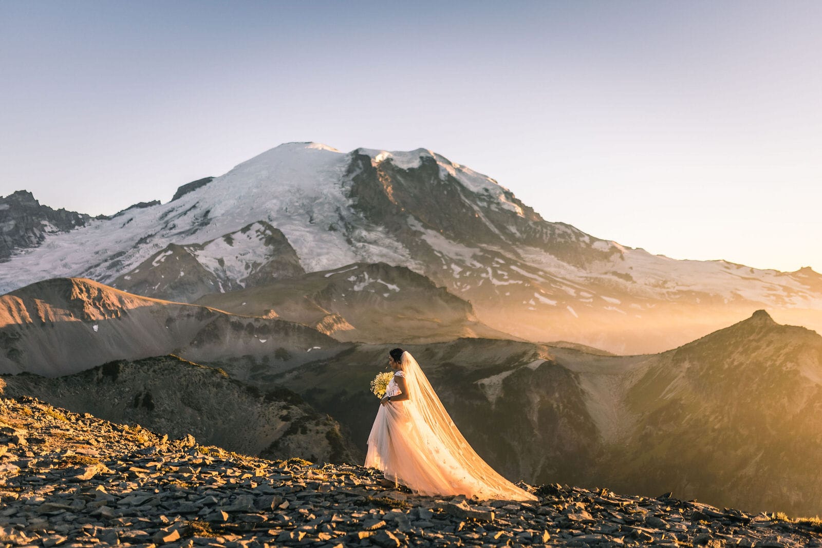 Just married bride portrait in golden sunlight with Mount Rainier in background