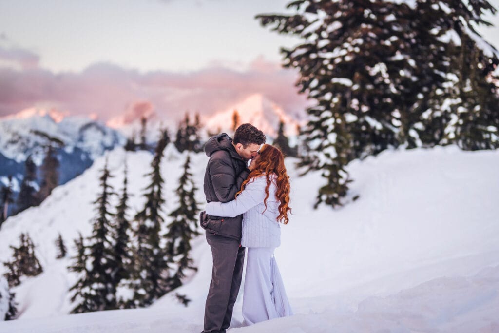 Couple kissing in North Cascades snowy mountains