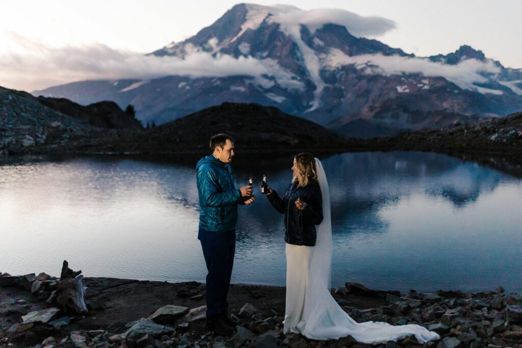 couple cheering after their mt rainier elopement wedding, taken by mt rainier elopement photographer